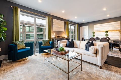 Open-concept living, kitchen, and dining area. 65” Samsung Smart TV that allows for streaming from your favorite apps, along with DIRECTV Entertainment.