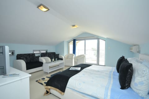 Comfort Triple Room, Sea View | Minibar, in-room safe, individually decorated, individually furnished