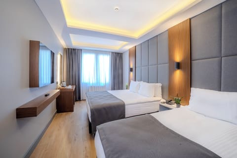 Superior Triple Room | Minibar, in-room safe, desk, laptop workspace