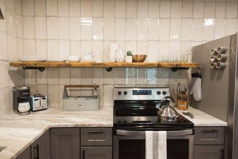 Single locally made shelf displays your basics for easy access. All the extras are stored in the lower cabinets.