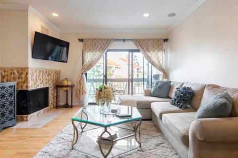 View of the living room as you enter the room with balcony.