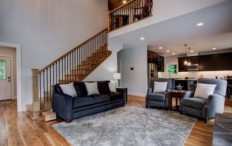 Living room area with stairs up to 2nd floor