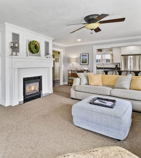 A bright and beautiful family room greets our guests with an open floor plan leading into the dining room and kitchen. French doors, recently added to access the new deck, hot tub and fire table.