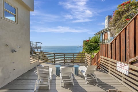 Sun-drenched deck w/ lounge chairs & sweeping ocean views just steps from the sand.