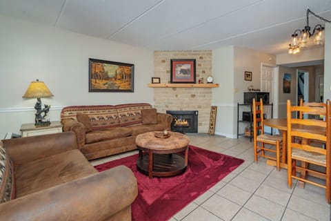 Sink into plush seating beside your gas fireplace, where rustic charm meets cozy comfort in your inviting living space.