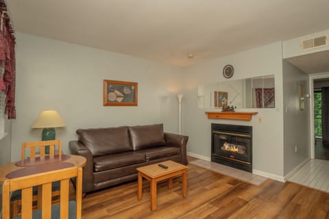 Sink into the plush leather sofa after your day's adventures, with warm firelight and peaceful views creating your perfect mountain retreat.