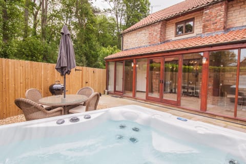 Enclosed garden with outside dining furniture, bbq and hot tub