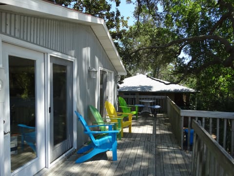 Shaded Deck with Adirondack Chairs and a outdoor dinning table.