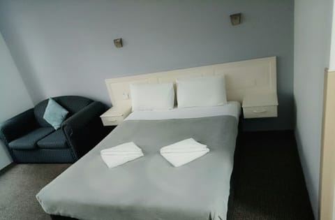Desk, iron/ironing board, bed sheets