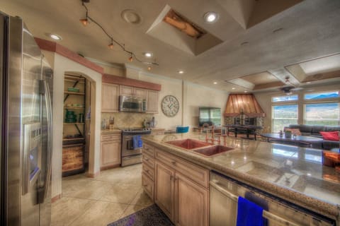 Gorgeous fully stocked and well equipped kitchen with the open concept design to not miss the conversation and views while cooking your delicious meal.