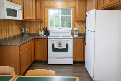 Fully equipped kitchen | Full-size stove, refrigerator, cookware & dining essentials.