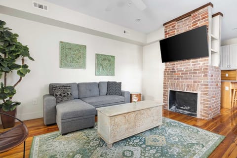 Welcome to your downtown Charleston rental! Living room space with a sleeper sofa + TV! 