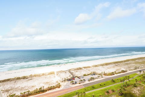 The property offers convenient access to pristine white sand beaches and turquoise waves, with coastal roads and parking areas nearby for easy exploration.