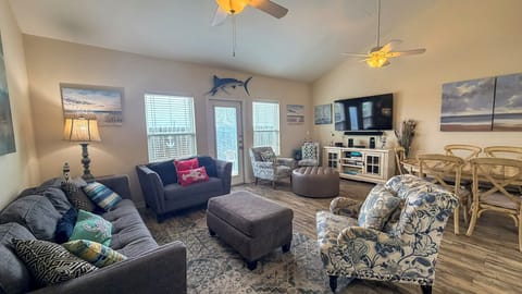 Sink into plush seating where coastal charm meets comfort—your perfect retreat for movie nights and morning coffee.