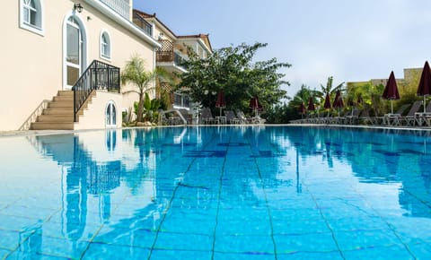 Seasonal outdoor pool, open 10:30 AM to 6:30 PM, pool umbrellas