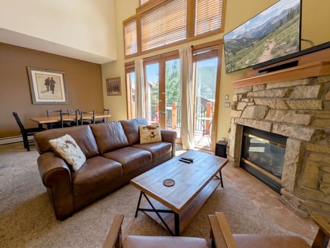 Settle into your cozy living room where a stone fireplace and mountain views create the perfect alpine retreat. Glass doors open to your private balcony for fresh air and mountain scenery.