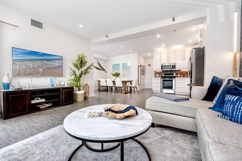 Living area with large Smart TV and L shaped sofa