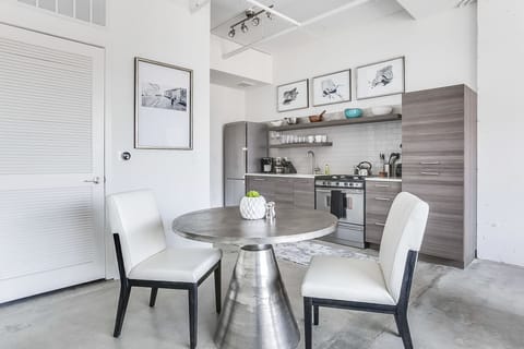 Dining area of this Apartment Near Ponce City Market, with the kitchen in the background.