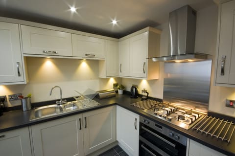 Fully fitted kitchen  with dining table leading off to sun-room
