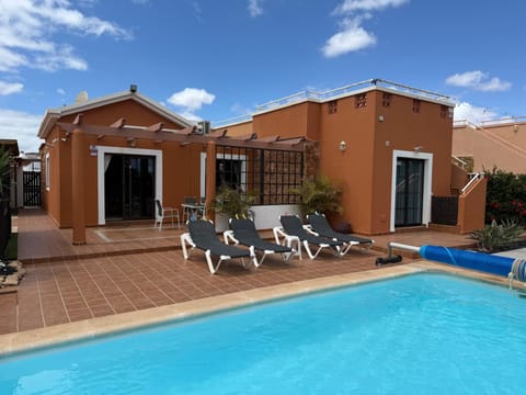 Pool, sunbathing area, bbq patio and hot tub
