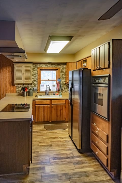 Kitchen with plates, pots and pans, crockpot and silverware 