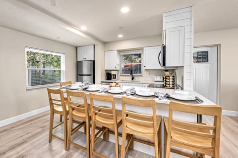 Stainless appliances and a beach-toned palette make this a functional and attractive space for group cooking.