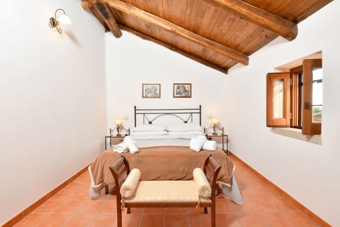 Comfortable spacious double bedroom on upper floor with wooden beams