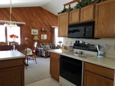 Open concept with view of great room, dining room and lake from kitchen.