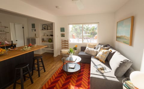 Living room seating with tons of light with window out to rooftop deck