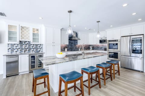 A stylish kitchen island with seating for casual breakfasts, evening appetizers, or chatting with the chef