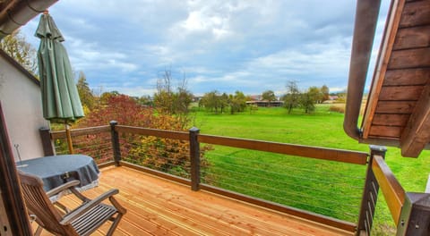 the window front from the living room to the balcony can be opened completely with view over green meadows and fields