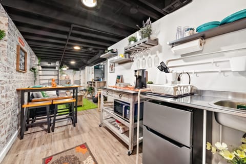 Full kitchenette with sink, fridge, microwave, and coffee station