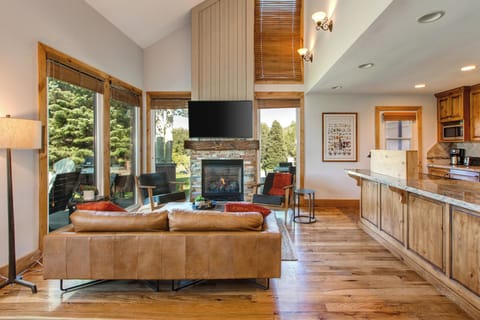 Bright Living Room Area with Comfortable Furnishings, 55" Smart TV, Gas Fireplace, and Hardwood Floors