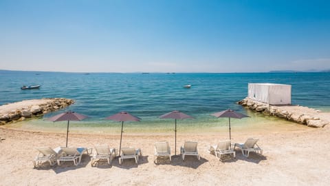 On the beach, sun loungers, beach umbrellas, beach bar