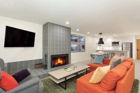 - Warm living area with a cozy fireplace and modern decor  
- Bright seating space with colorful cushions for relaxing nights  
- Perfect setup for movie time after Whistler adventures  
