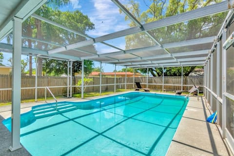 Large screened swimming pool with a shallow end Heated saltwater swimming pool with a shallow end and deep end.  and deep end.