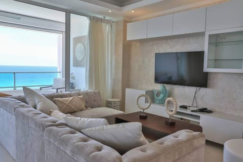 Living room and balcony of this luxury beachfront at 12floor Marbella Juan Dolio. 