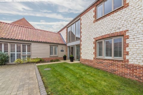 Anchorage, Brancaster:  Front elevation with parking for three cars