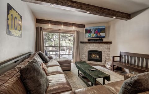 Living Room area with extra large couch, balcony and open to kitchen