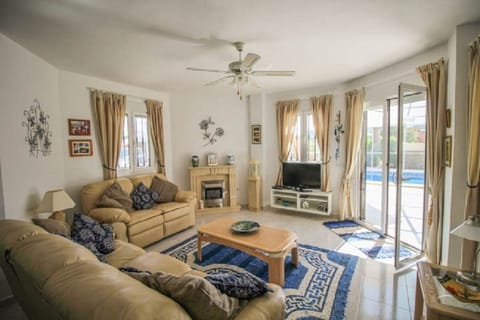 Family Room (Lounge) with double patio doors leading to the terrace and pool.