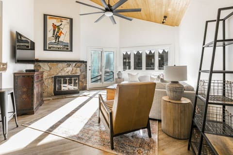 Large spacious living area with gear storage and cozy fire.