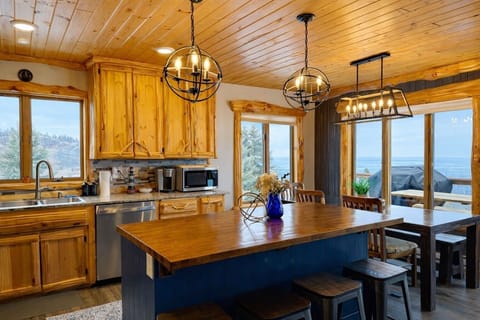 The bright updated kitchen with stainless appliances, modern finishes, and a stunning Lake Superior backdrop come into view as you first come into the room.
