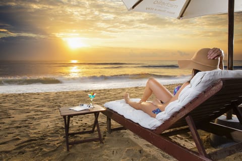 On the beach, white sand, sun loungers, beach umbrellas
