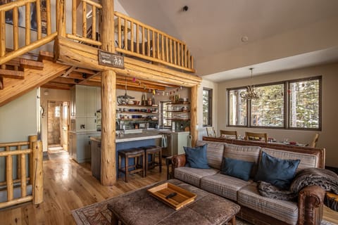 Relax in your cozy mountain retreat with handcrafted log beams, plaid furnishings, and forest views from every window.