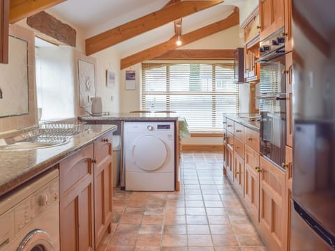 Tile-floored kitchen | The Byre - Lyserry Barns, Bosherston, near Pembroke