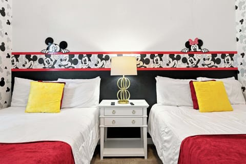 Mickey Mouse themed bedroom with two beds