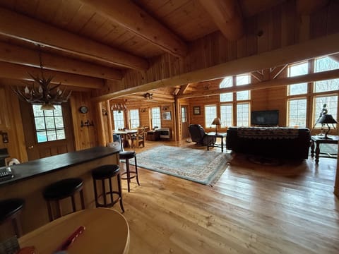 View from full kitchen with four counter stools.