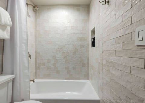 Shower, designer toiletries, hair dryer, towels