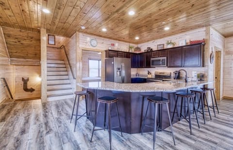 Kitchen peninsula has chairs for six.
