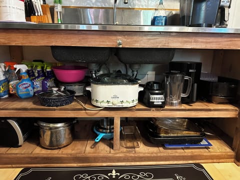 Pots and pans, blender, crockpot, air fryer, all can be found under the sink